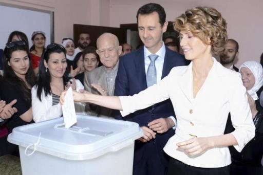 Syria's President Bashar al-Assad and his wife Asma (R) cast their votes in the country's presidential elections at a polling station in Damascus June 3, 2014, in this handout released by Syria's national news agency SANA. REUTERS/SANA/Handout via Reuters